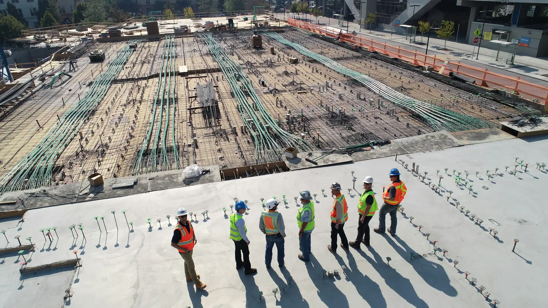 Enlight team reviewing plans on an aerial development site